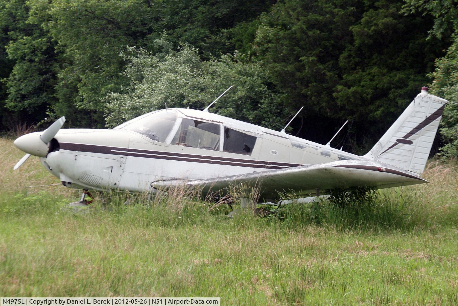 N4975L, 1967 Piper PA-28-180 C/N 28-4349, A few years after I saw this aircraft last, it had been moved to another area of the airport; however, she still remains mired in a sea of tall grass and deer ticks.