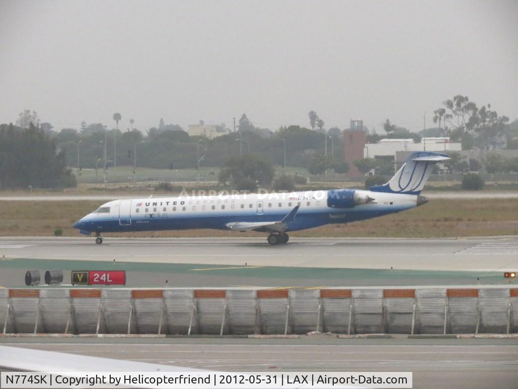 N774SK, 2006 Canadair CL-600-2C10 Regional Jet CRJ-700 C/N 10240, Taking off on 24L during an overcast day