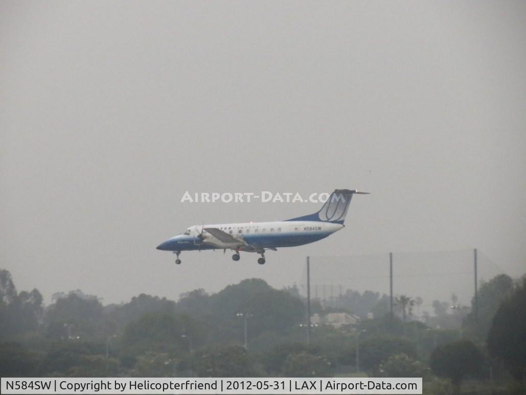 N584SW, 1999 Embraer EMB-120ER Brasilia C/N 120352, Landing on 24R during an overcast day