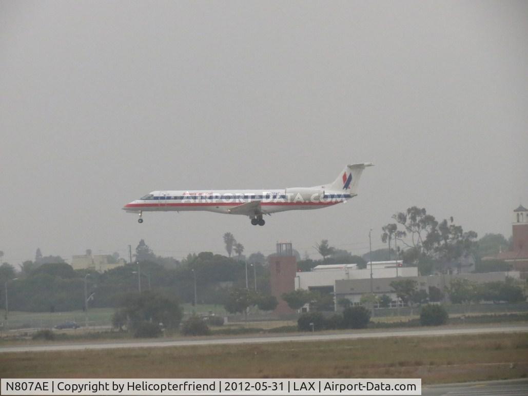 N807AE, 2001 Embraer ERJ-140LR (EMB-135KL) C/N 145506, Landing on 24R during an overcast day