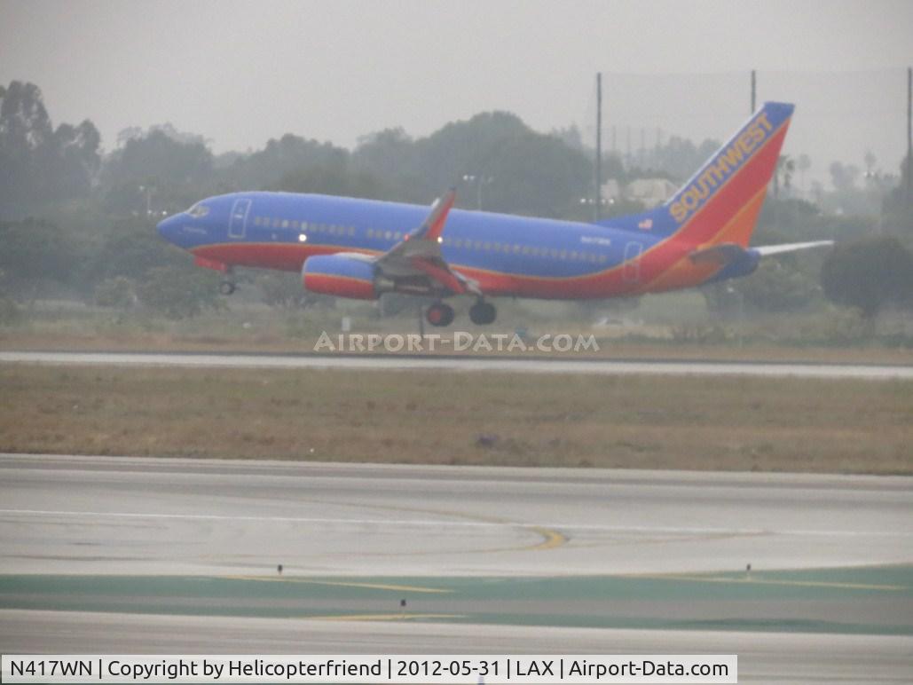N417WN, 2001 Boeing 737-7H4 C/N 29822, Ready to  touch down on runway 24R during a very overcast day