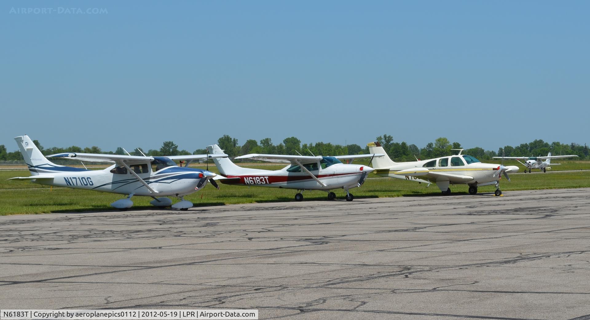 N6183T, Cessna R182 Skylane RG C/N R18201930, N1710G, N6183T and an unidentified aircraft are seen on the tarmac at Lorain County Regional Airport.