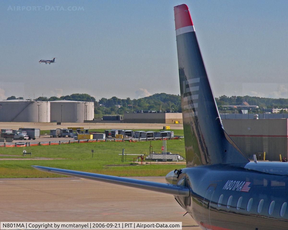N801MA, 2004 Embraer 170SU (ERJ-170-100SU) C/N 17000012, The tail of the US Airways Express Embraer ERJ 170 waiting to take me to Charlotte as another aircraft approaches PIT
