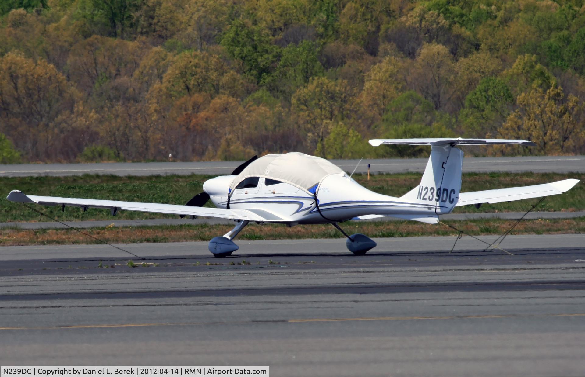 N239DC, 2008 Diamond DA-40 Diamond Star C/N 40.968, Underneath the sun-protection shroud is a sleek aircraft.