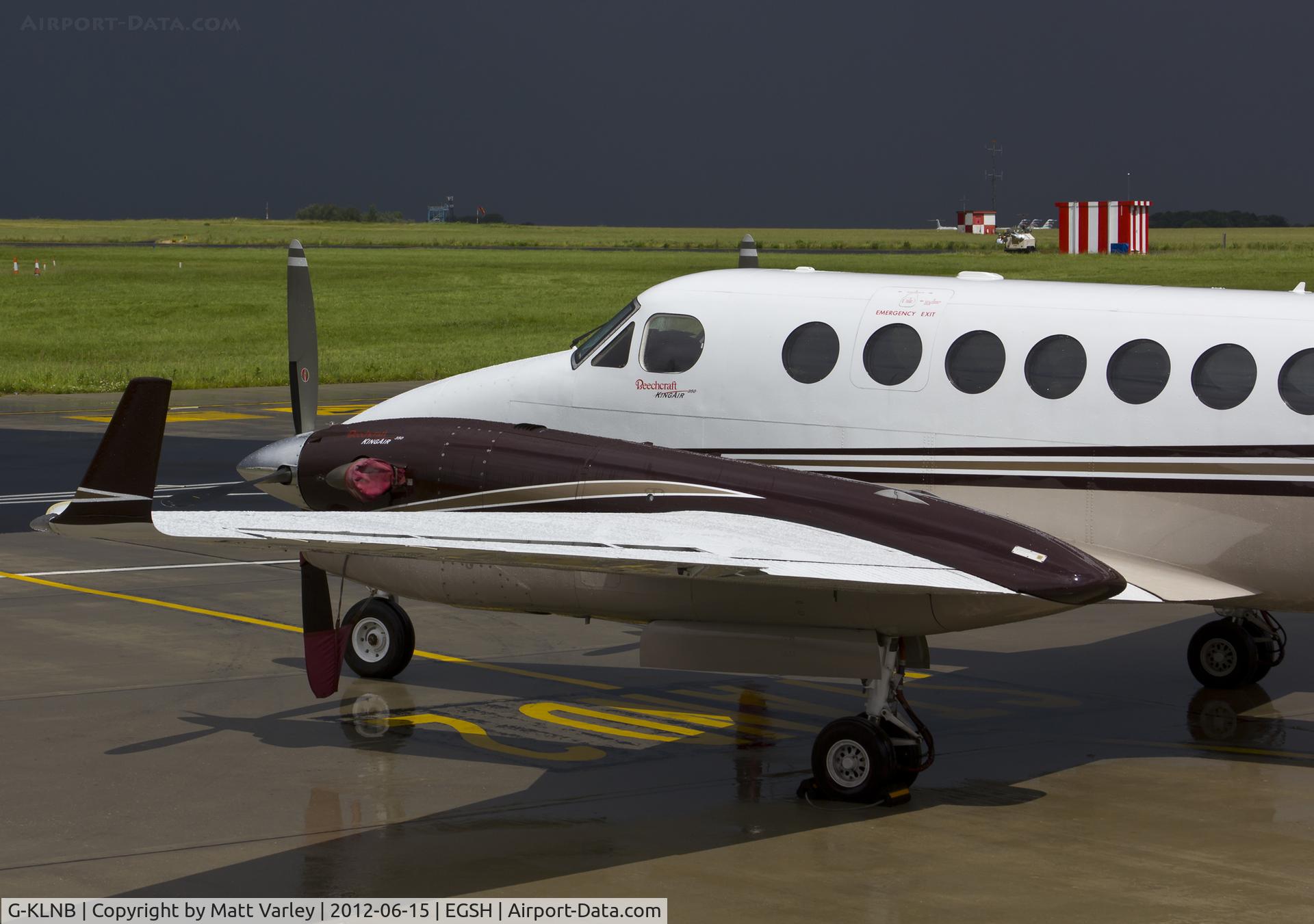 G-KLNB, 2009 Beech Super King Air 350 C/N FL-631, Sat on stand at SaxonAir after a thunder storm.