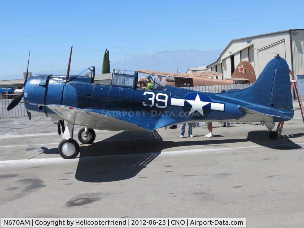 N670AM, 1993 Douglas SBD-5 Dauntless C/N 28536, Helping get the passenger ready for a flight