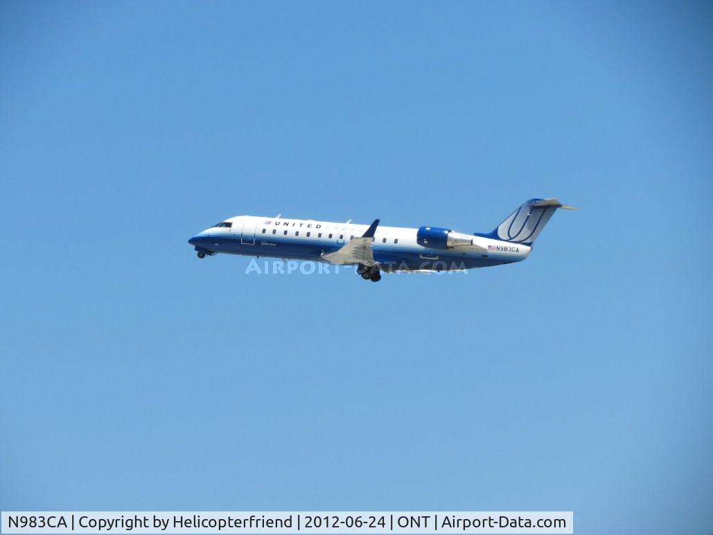 N983CA, 1997 Canadair CRJ-100ER (CL-600-2B19) C/N 7169, After exchanging passengers, climbing out from 26R, gear retracting