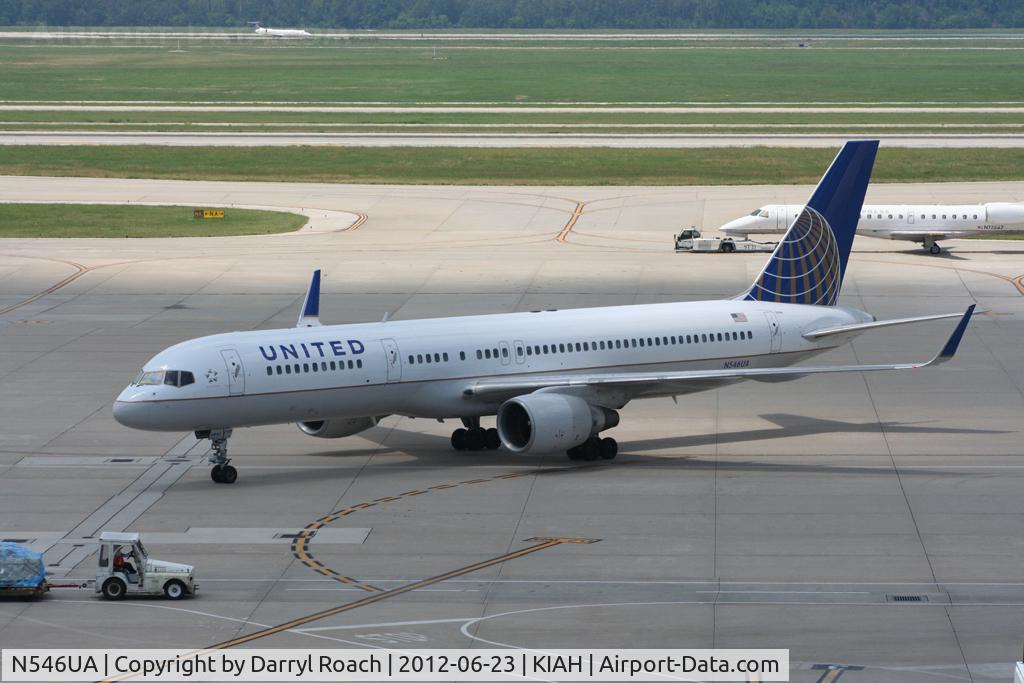 N546UA, 1991 Boeing 757-222 C/N 25367, UAL B752 is marshaled to its gate as company E145 is towed behind.