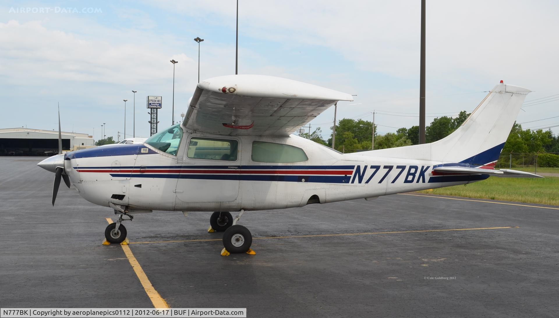 N777BK, 1974 Cessna 210L Centurion C/N 21060560, N777BK seen through the fence at KBUF.