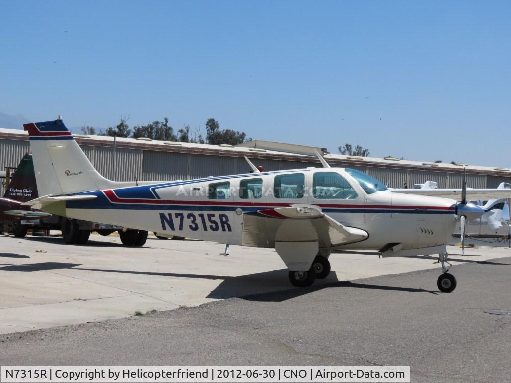 N7315R, 1974 Beech A36 Bonanza 36 C/N E-558, Parked near a mechanic's hanger