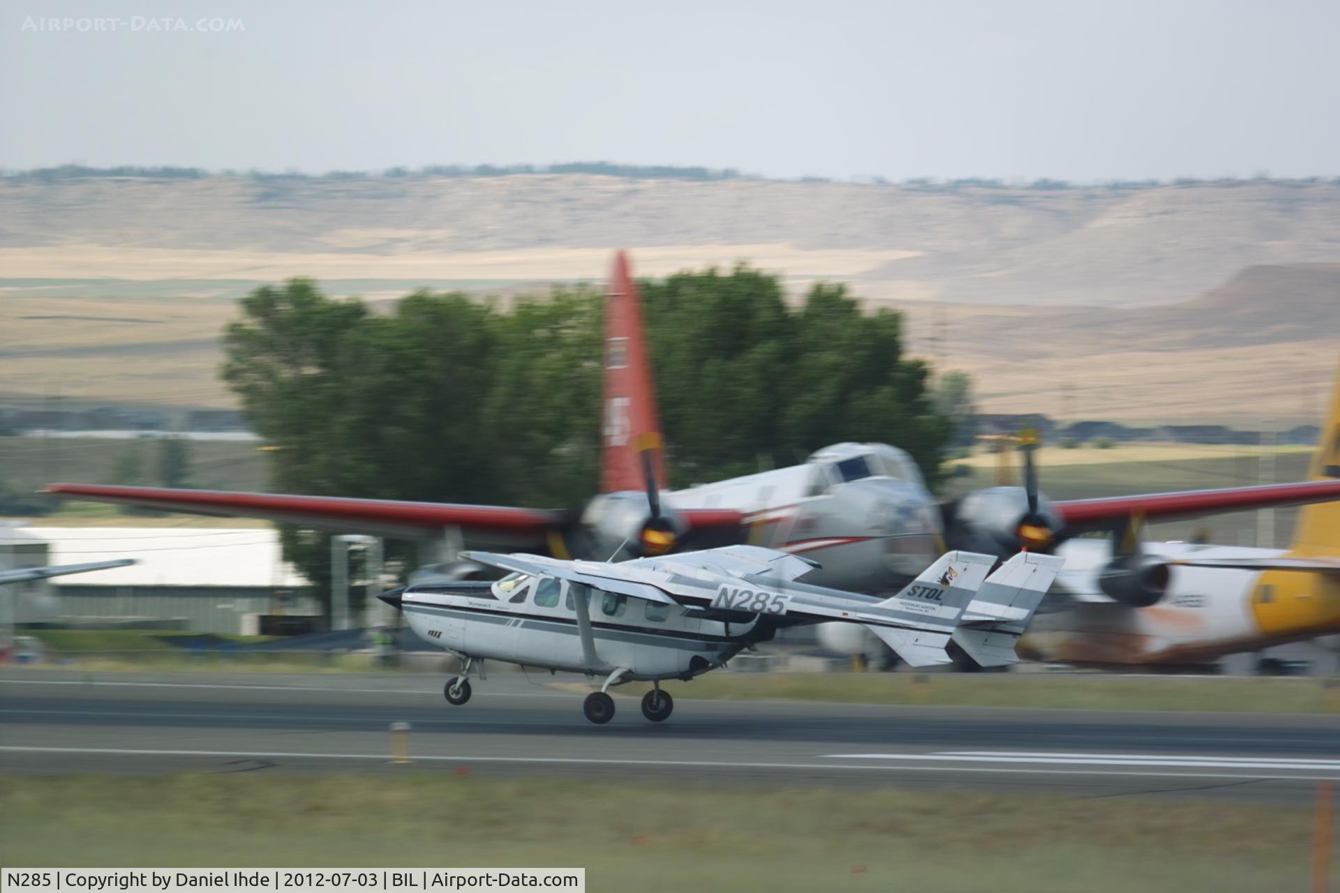 N285, 1975 Cessna T337G Turbo Super Skymaster C/N P3370228, Cessna 337 dwarfed by a Neptune tanker.