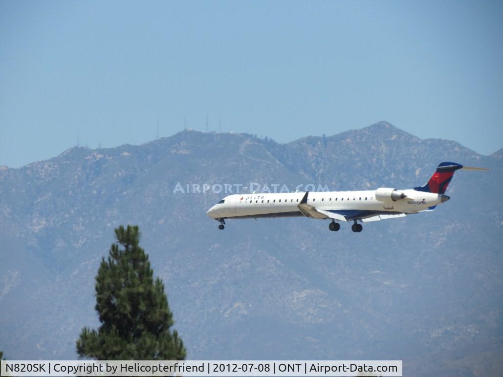 N820SK, 2006 Bombardier CRJ-900ER (CL-600-2D24) C/N 15108, Over the outer fence for 26R
