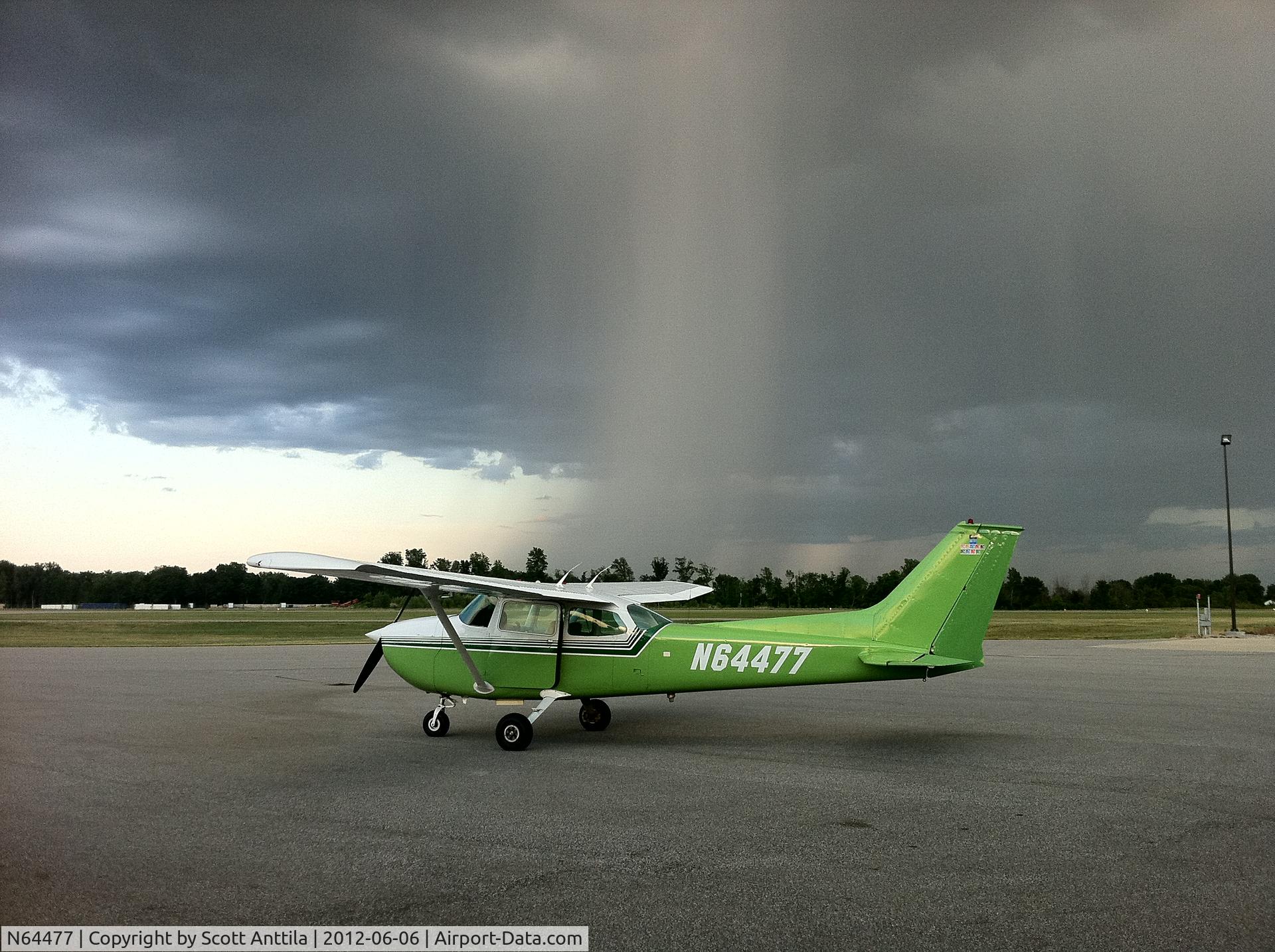 N64477, 1975 Cessna 172M C/N 17265257, Parked at the Romeo airport Ramp in Michigan waiting out a small rain cell with lightning.