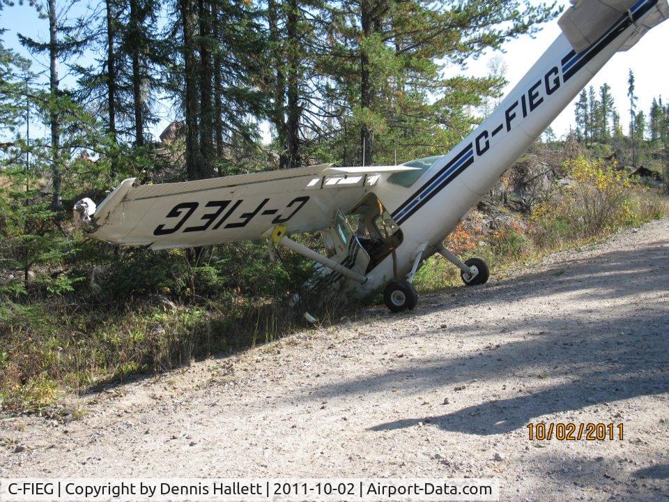 C-FIEG, 1975 Cessna 150M C/N 15076564, On way to Yellowknife from Montreal, Pilot had enging trouble.  Tried to land on this road, but clipped a tree.  No Injuries.