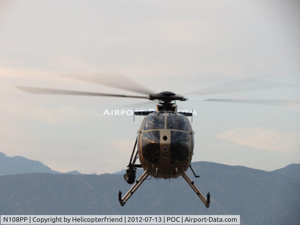 N108PP, 2008 MD Helicopters 369E C/N 0578E, Air taxiing into the fence enclosed helipad at hanger