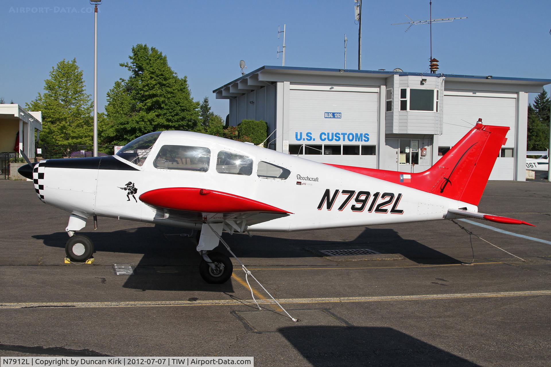 N7912L, 1966 Beech A23-19 C/N MB-129, This Musketeer wears a Texas flag and could be a long way from home