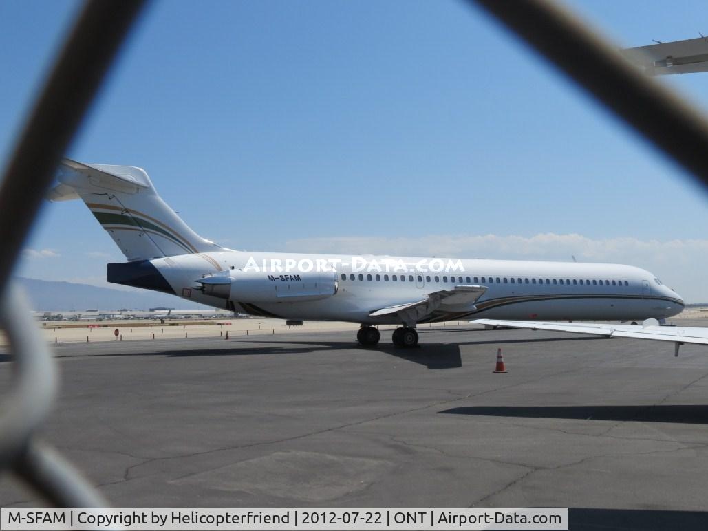 M-SFAM, 1992 McDonnell Douglas DC-9-87 C/N 53042, Parked behind the fence at Executive Terminal