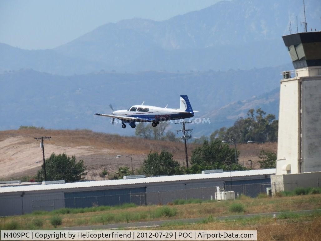 N409PC, 2007 Mooney M20R Ovation C/N 29-0488, Climbing out passing the tower, retracting landing gear