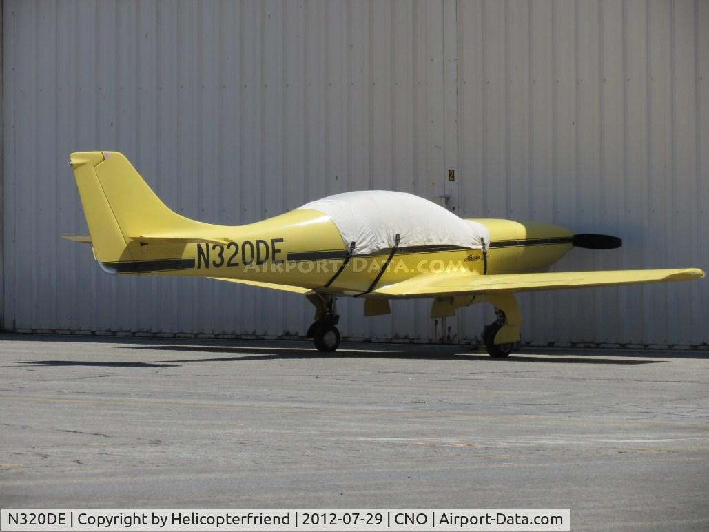 N320DE, 1991 Lancair 320 C/N 385, Covered up and parked next to a hanger