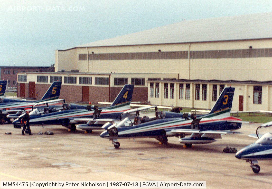 MM54475, Aermacchi MB-339MB C/N 6670, MB-339B, callsign India 4477, number 3 of the Italian Air Force's Frecce Tricolori aerobatic team with others on the flight-line at the 1987 Intnl Air Tattoo at RAF Fairford.