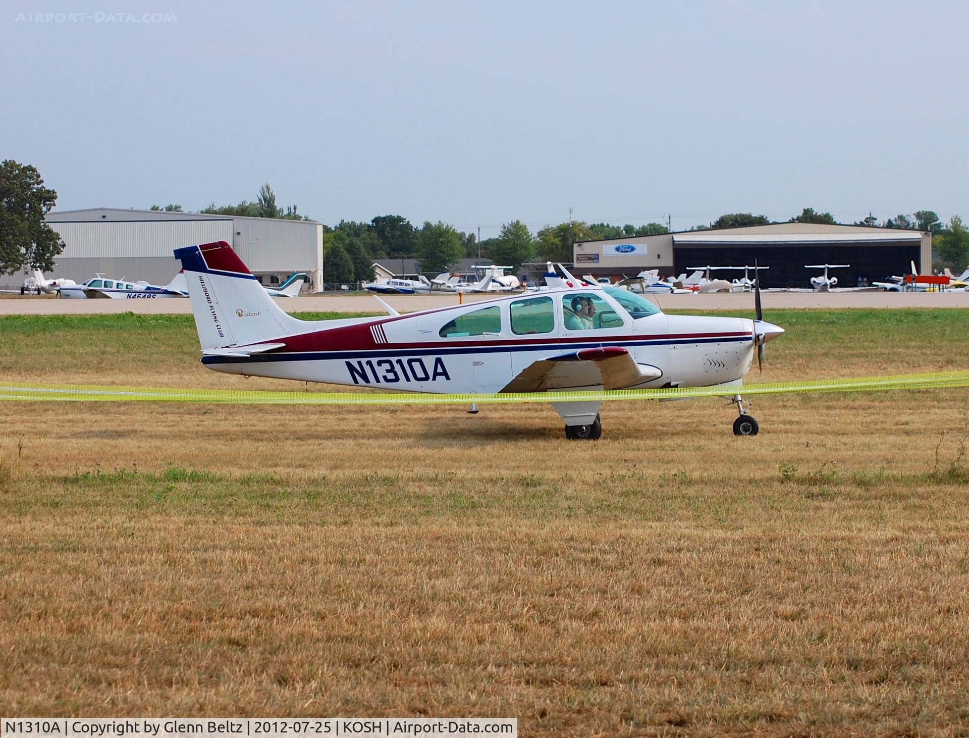 N1310A, 1967 Beech 35-C33 Debonair C/N CD-1105, Taxiing at Oshkosh on 25 July 2012.