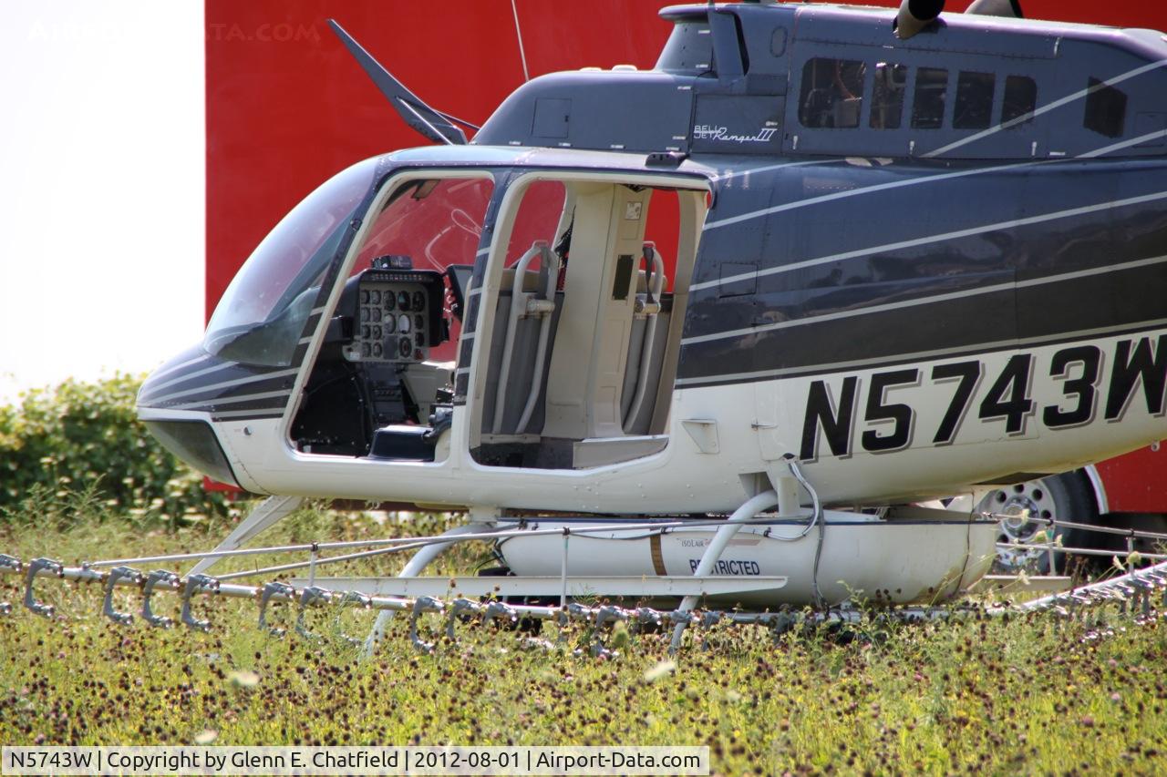 N5743W, 1980 Bell 206B C/N 3050, Taking on another load for crop dusting. At the SE corner of county routes W38 and A38, about six miles NE of Decorah, IA