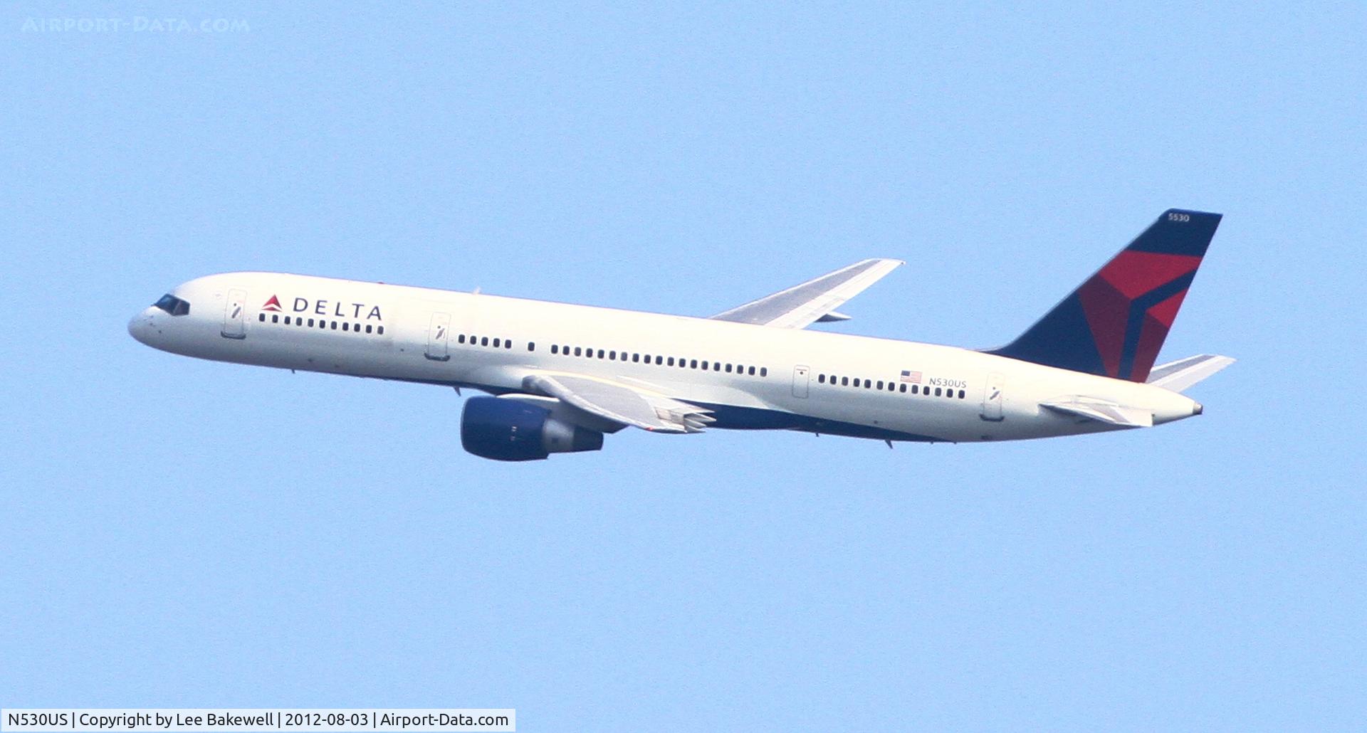 N530US, 1988 Boeing 757-251 C/N 23845, Delta climbing out the end of MSP Runway 12 (L or R?).  Photo taken from Sunfish Lake.