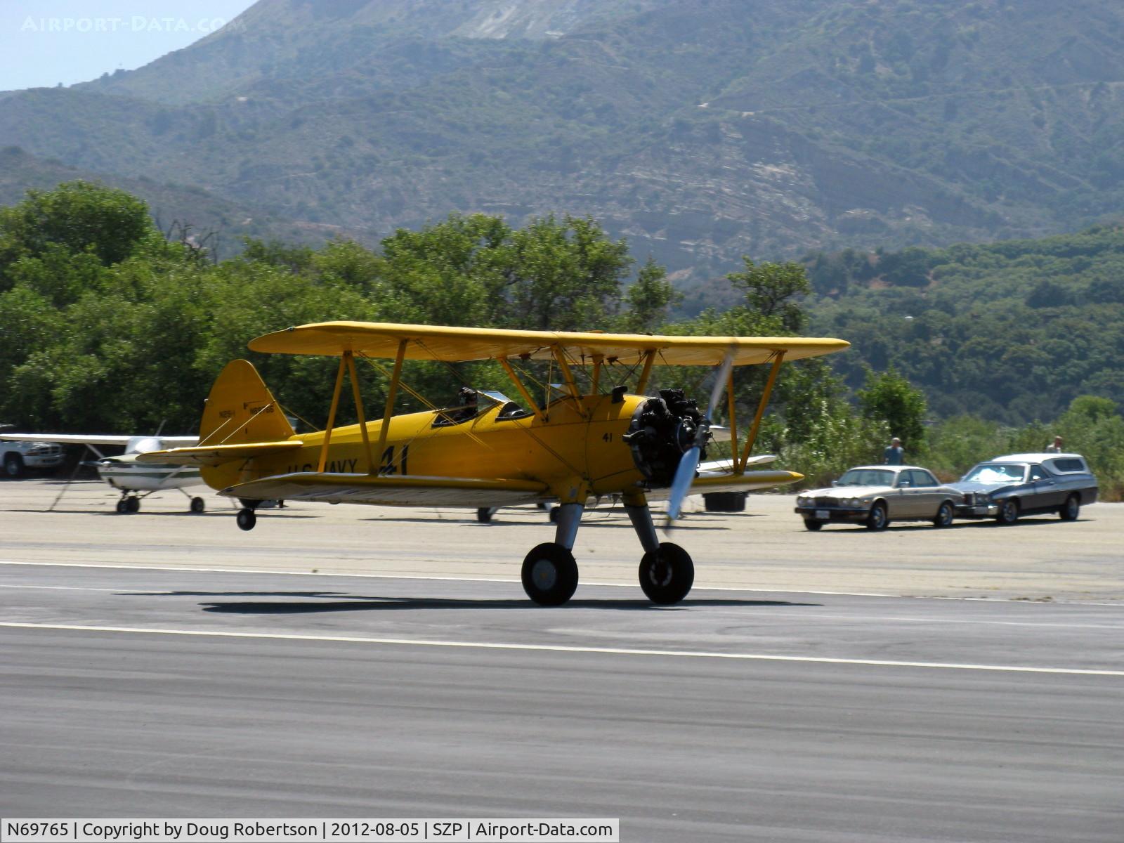 N69765, 1941 Boeing A75N1 (PT17) C/N 75-1044, 1941 Boeing Stearman A75N1 as Navy N2S1, Continental W670 220 Hp, landing roll Rwy 22. This plane occasionally easily takes off using the last third of Rwy 22