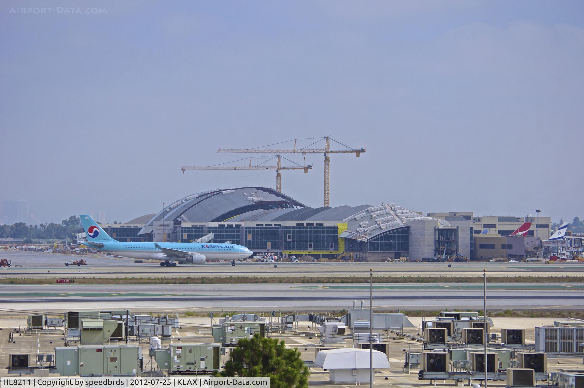 HL8211, 2010 Airbus A330-223 C/N 1133, Korean Air taxiing with the new Tom Bradley terminal in the background