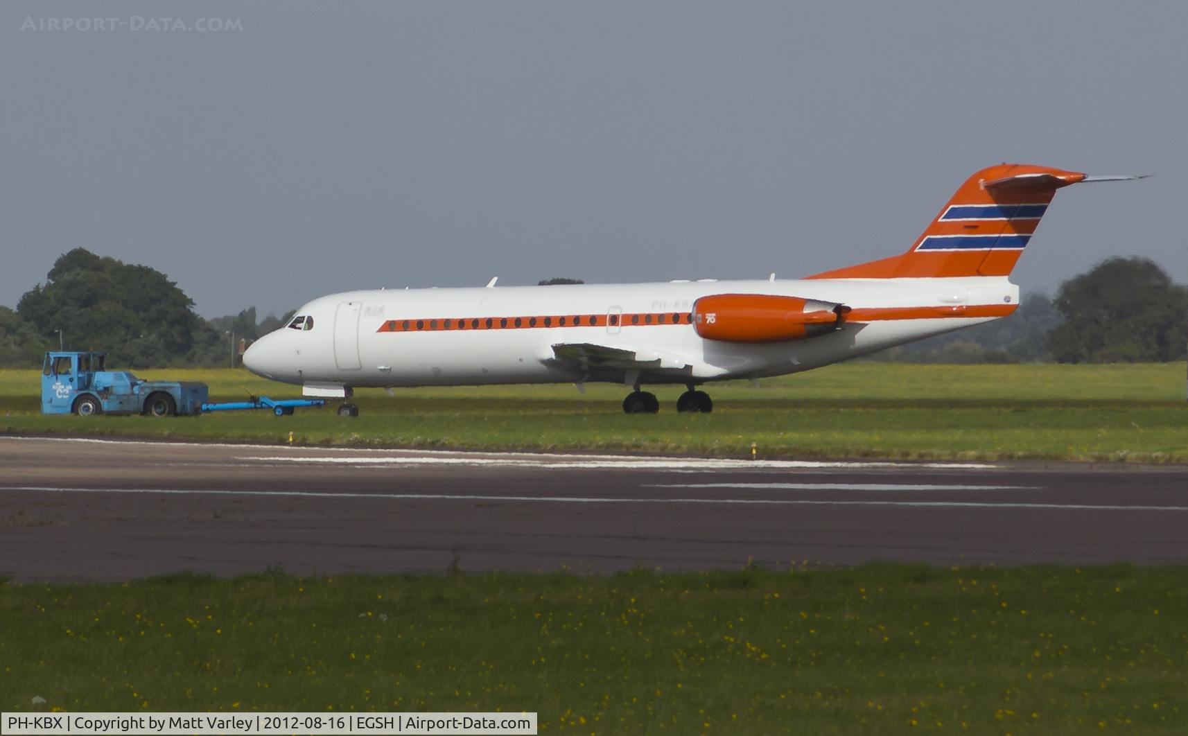 PH-KBX, 1996 Fokker 70 (F-28-0070) C/N 11547, Being towed from the northern to the eastern apron. (Very long crop shot)