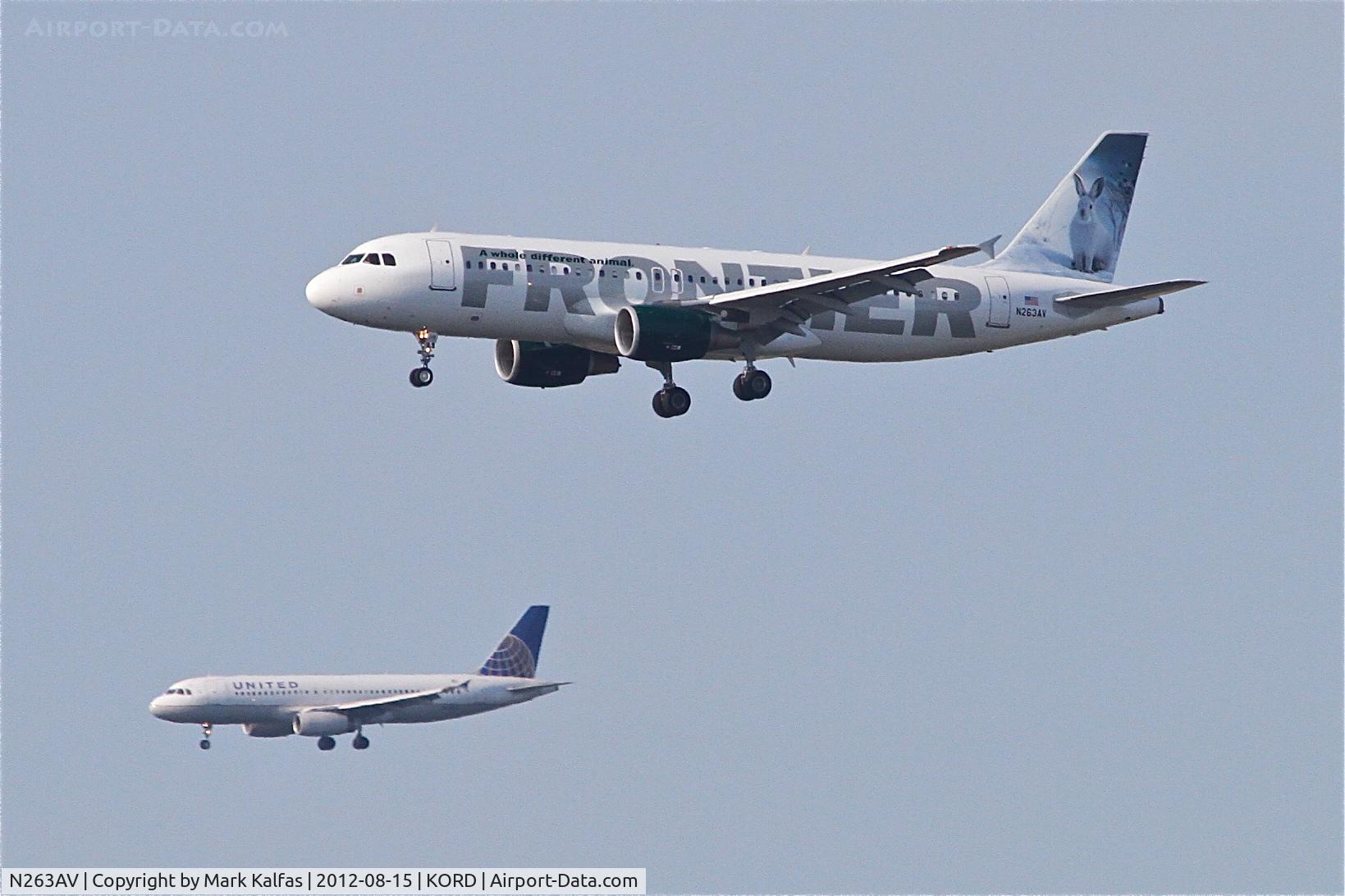 N263AV, 2002 Airbus A320-214 C/N 1860, Frontier Airlines Airbus A320-214, FFT41 arriving from Punta Cana/MDPC, RWY 27L approach and UAL246 (in the lower background) arriving from Vancouver/CYVR.