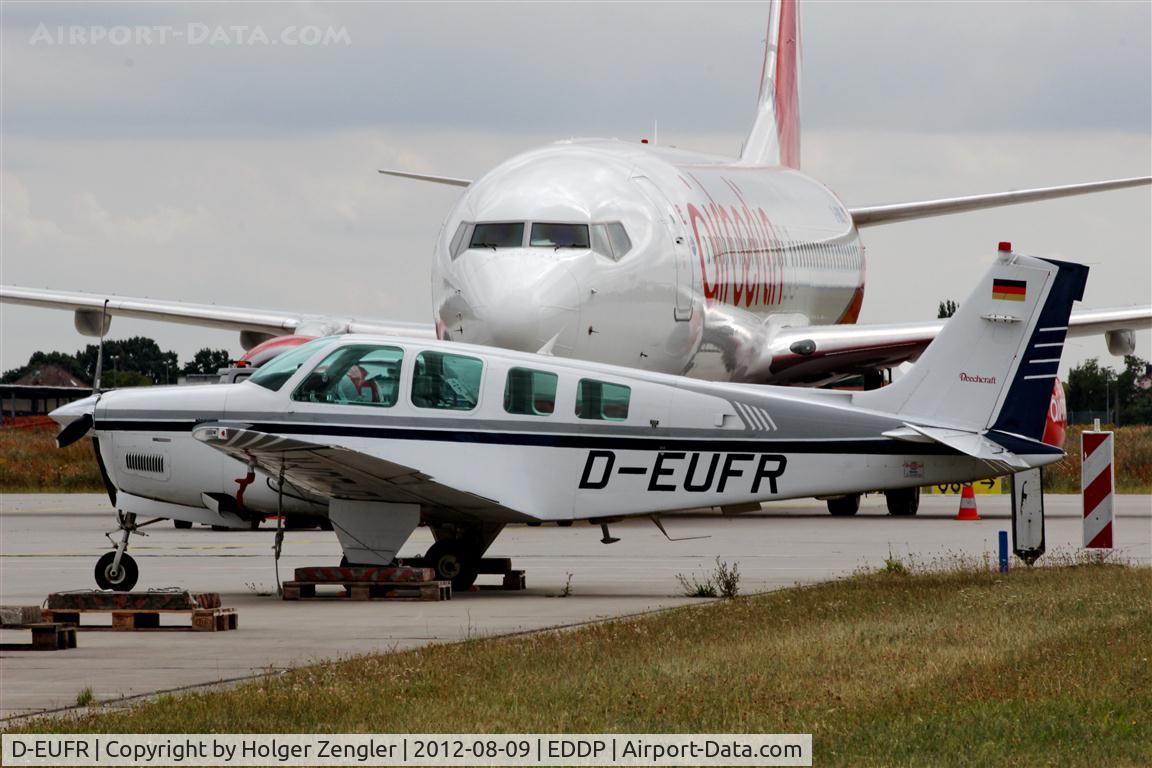 D-EUFR, Raytheon Aircraft Company A36 Bonanza C/N E-3021, Resting in the shadow of something bigger.....