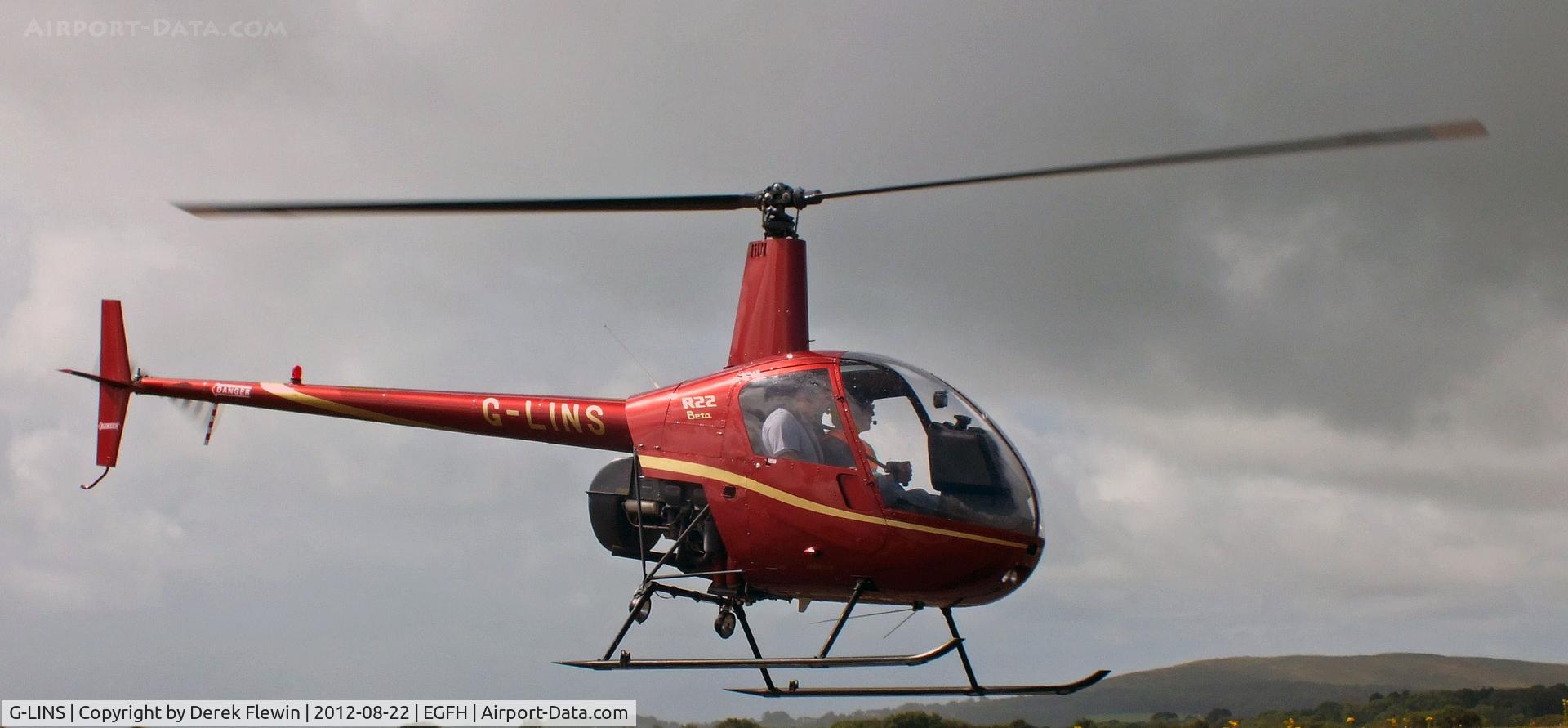G-LINS, 1989 Robinson R22 Beta C/N 1201, Close to the fence prior to departing for local flight.