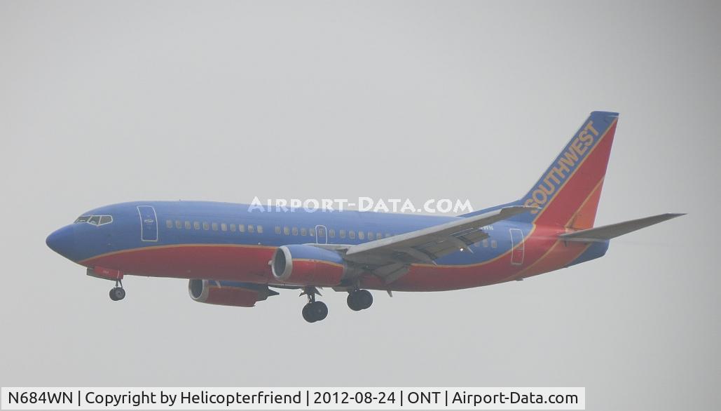 N684WN, 1988 Boeing 737-3TO C/N 23941, Coming out of the overcast on final for 26R