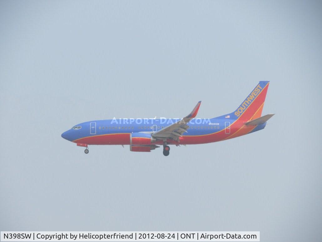 N398SW, 1995 Boeing 737-3H4 C/N 27692, Coming out of the overcast on final for 26R