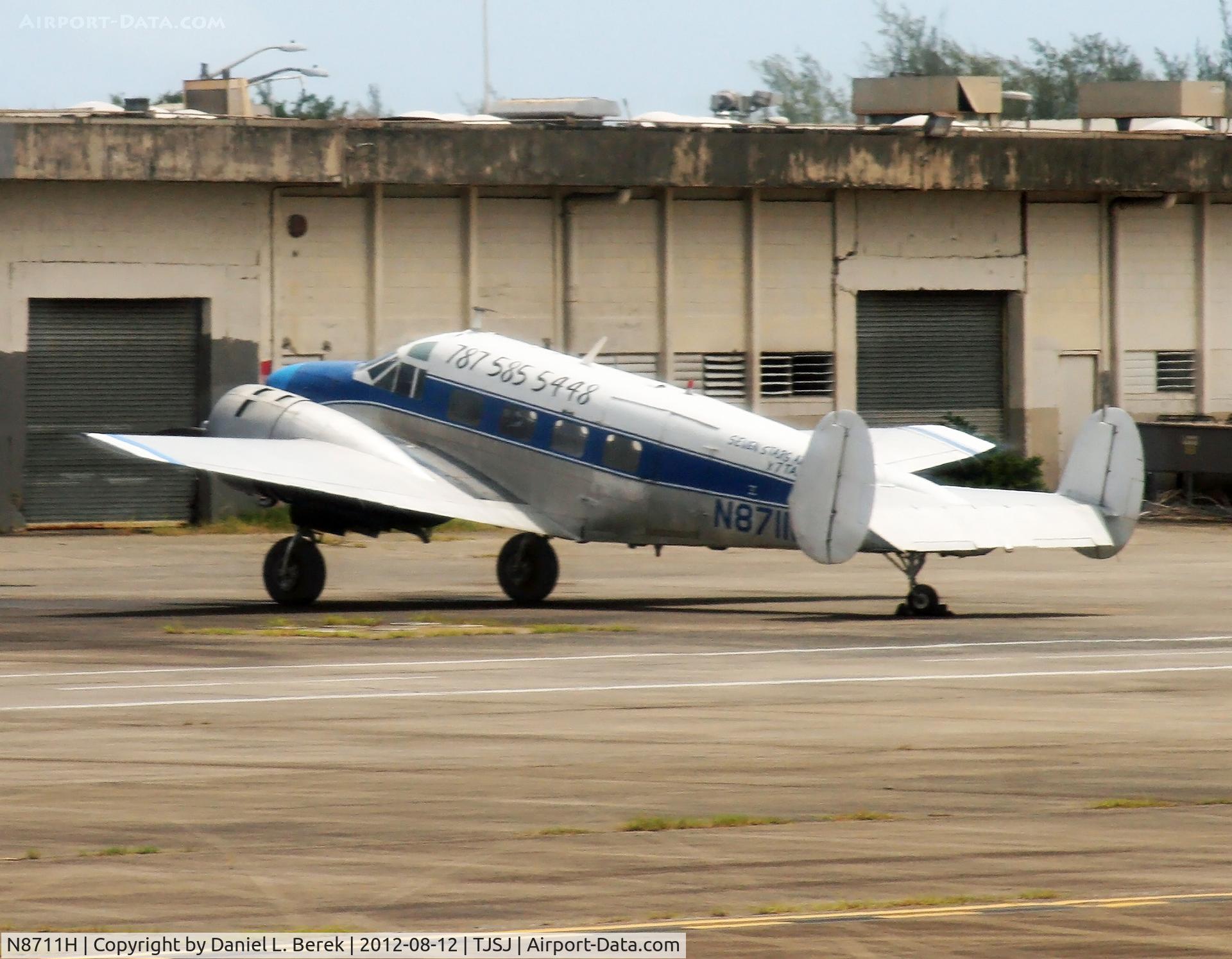 N8711H, 1955 Beech E18S C/N BA-87, A Seven Stars Air Cargo twin Beech rests at one of the cargo terminals at SJU.