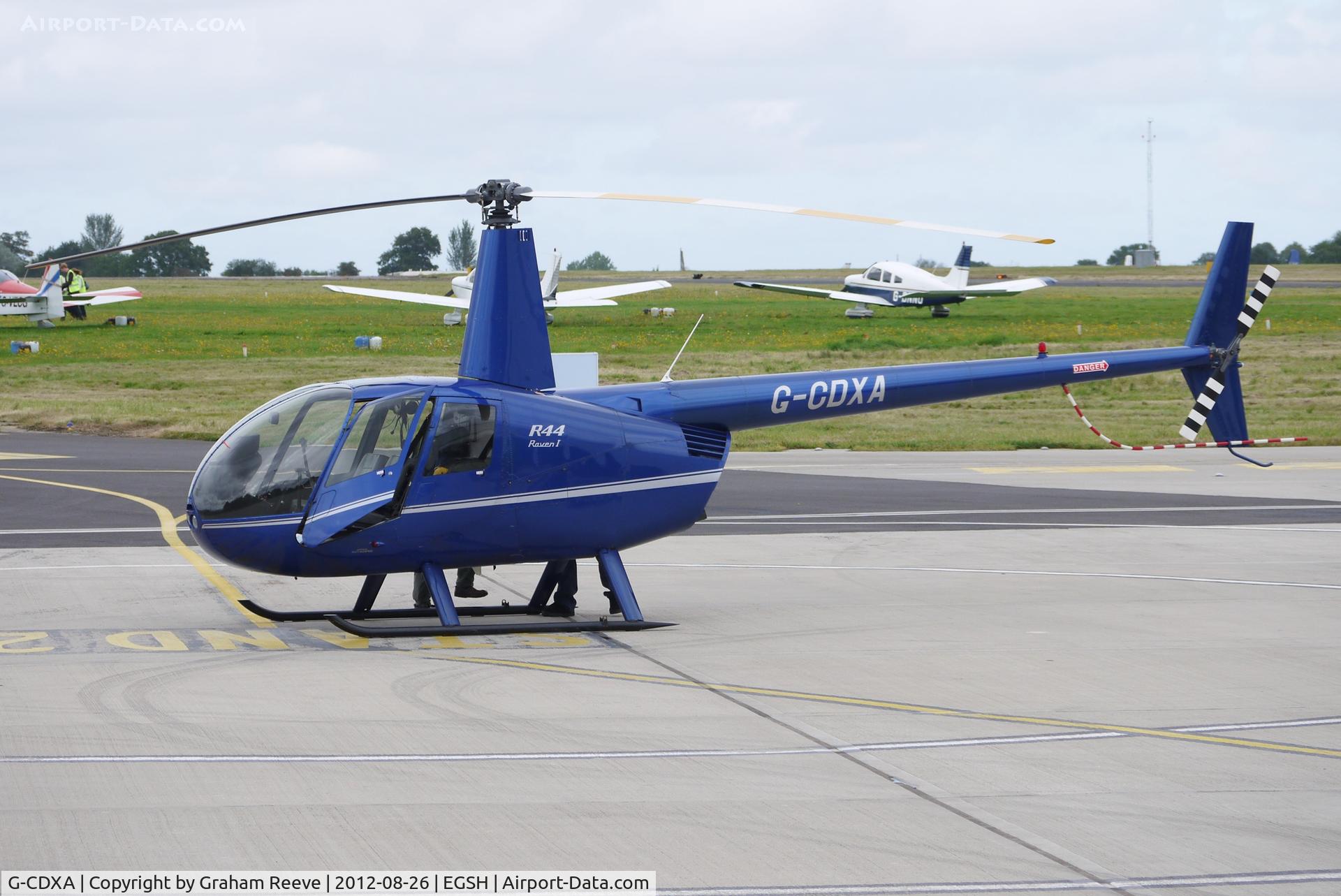 G-CDXA, 2006 Robinson R44 Raven I C/N 1584, Parked at Norwich.