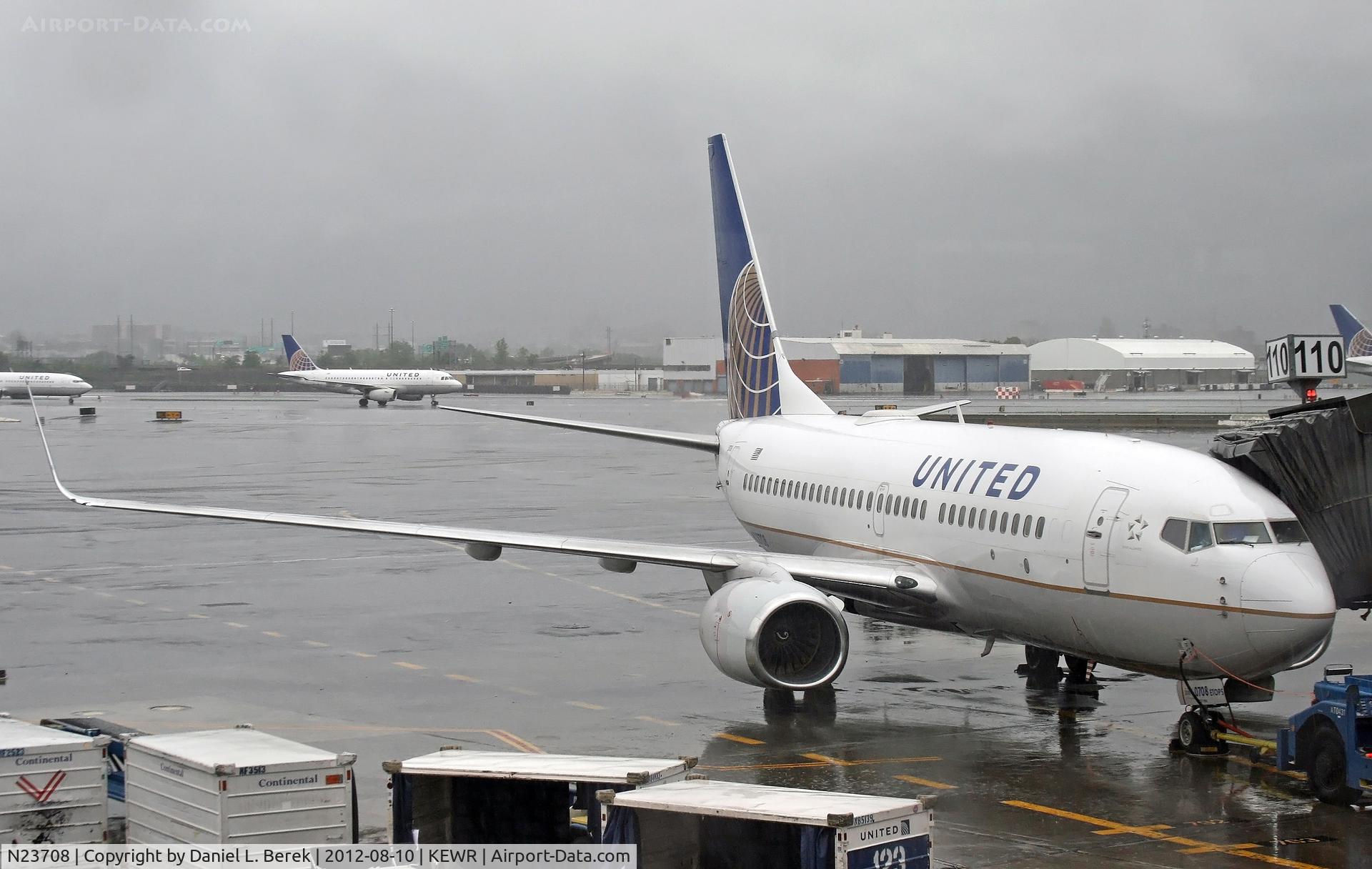 N23708, 1998 Boeing 737-724 C/N 28769, A United 737-700 waits out a downpour at Newark Liberty International Airport.