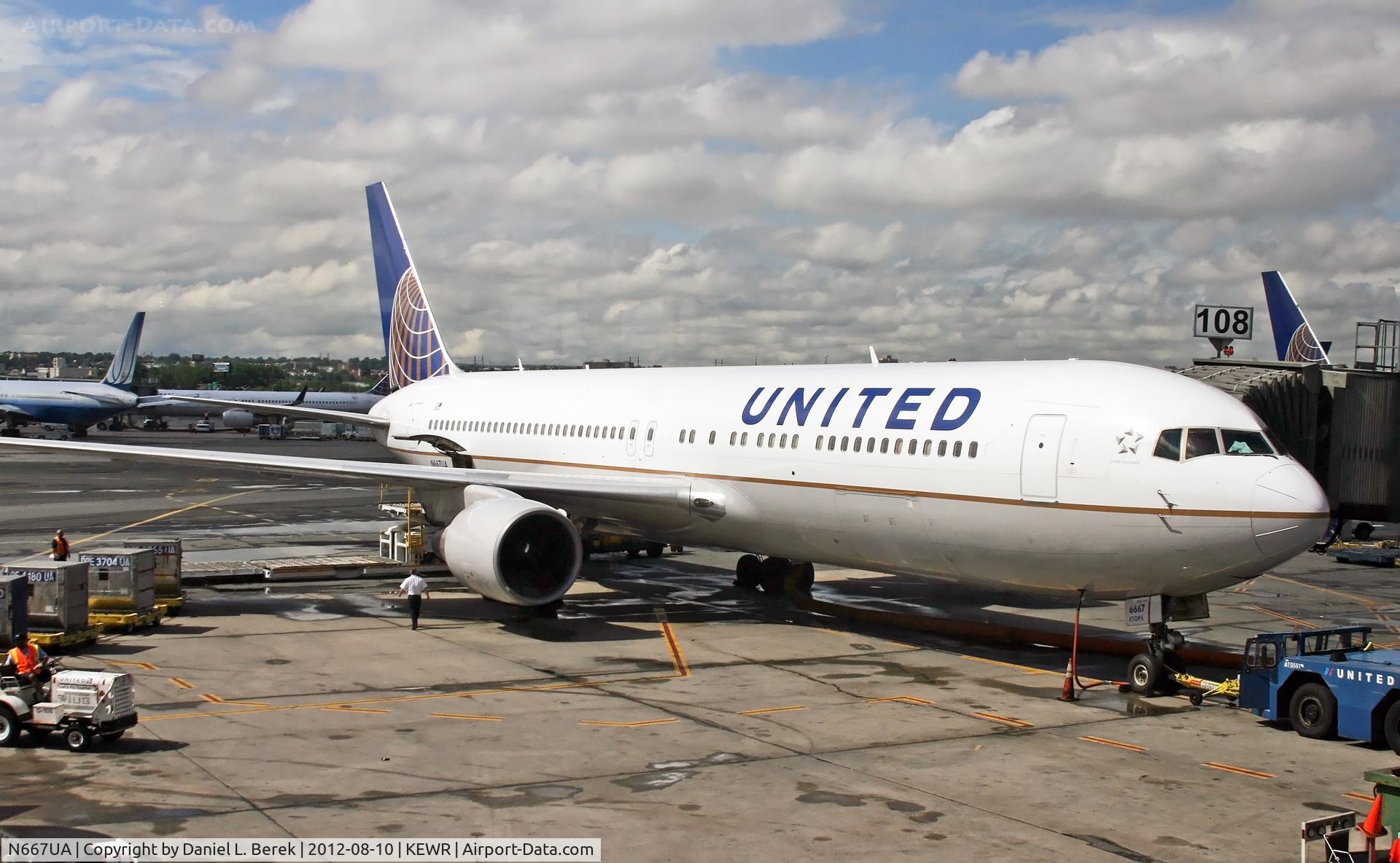 N667UA, 1998 Boeing 767-322 C/N 29239, A newly repainted UA 767-322/ER awaits its next journey on a stormy day at Newark.