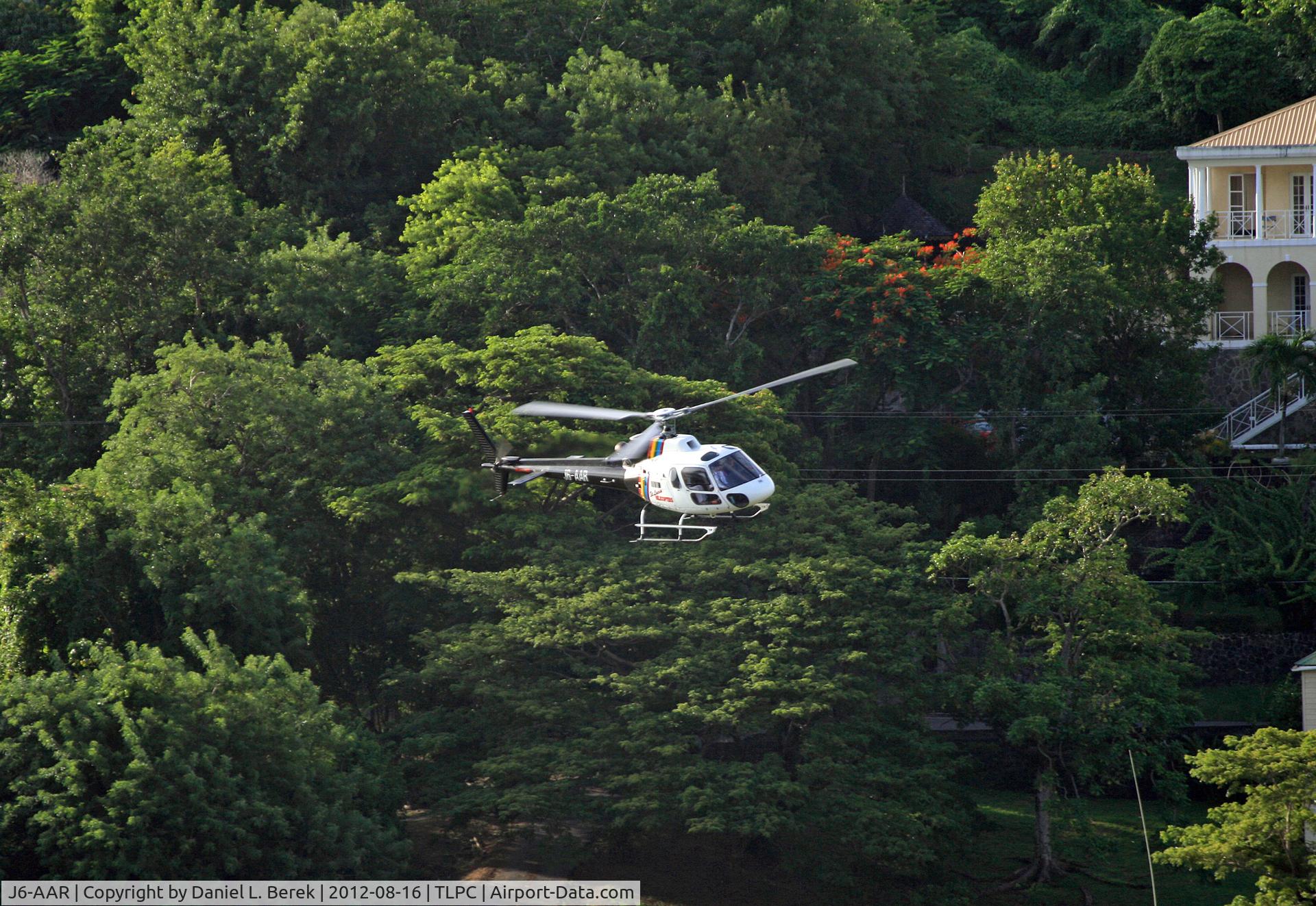 J6-AAR, Aerospatiale AS-350B Ecureuil C/N 3869, A tour helicopter, having just taken off from SLU, overflies the hills surrounding Castries harbor.  The scenery from the helicopter must be spectacular.
