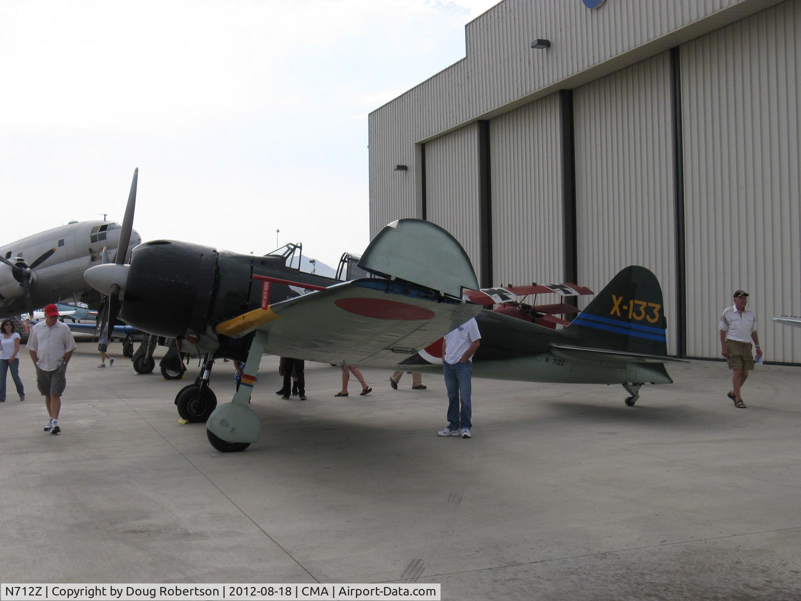 N712Z, 1942 Mitsubishi A6M3 Reisen (Zero) C/N 3869, 1942 Mitsubishi A6M ZERO-SEN (Allied codename ZEKE), P&W R-1820 Double Wasp upgrade from original Nakajima Sakai, wing folded per Japanese aircraft carrier stowage, at CAF ramp