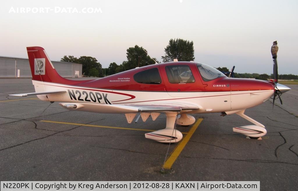 N220PK, Cirrus SR22T C/N 0004, Cirrus SR22T on the line. Notice the owl on the prop to scare birds off.