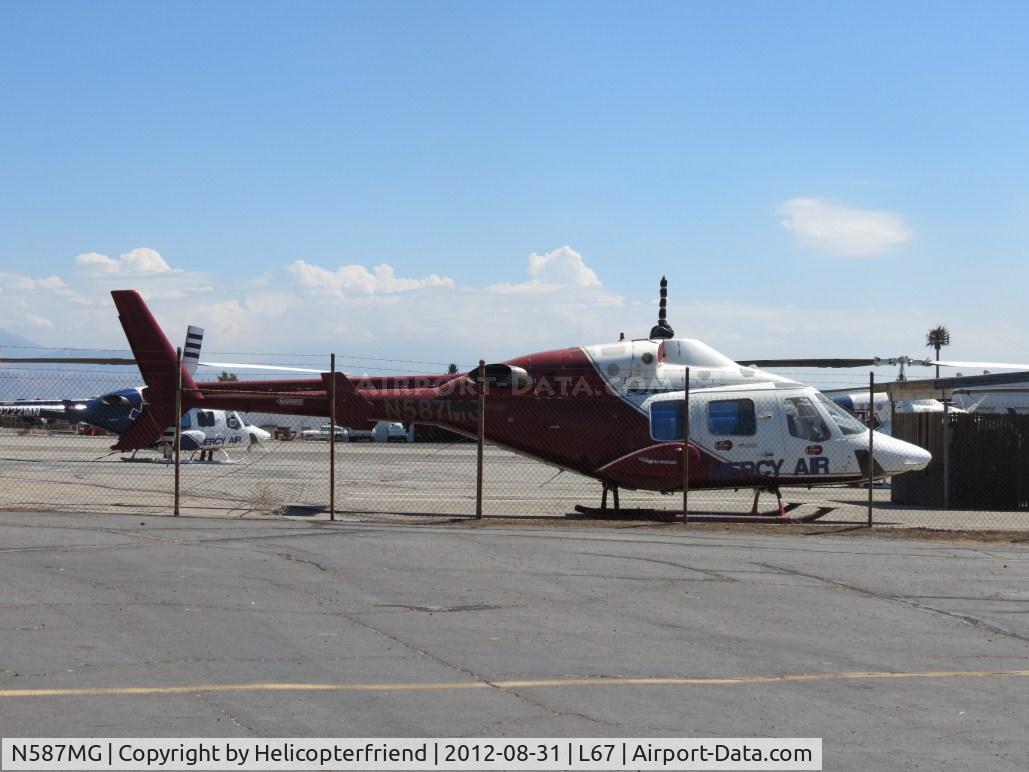 N587MG, 1987 Bell 222U C/N 47566, Parked next to the fence and appears to be out of service at Mercy Air Lot
