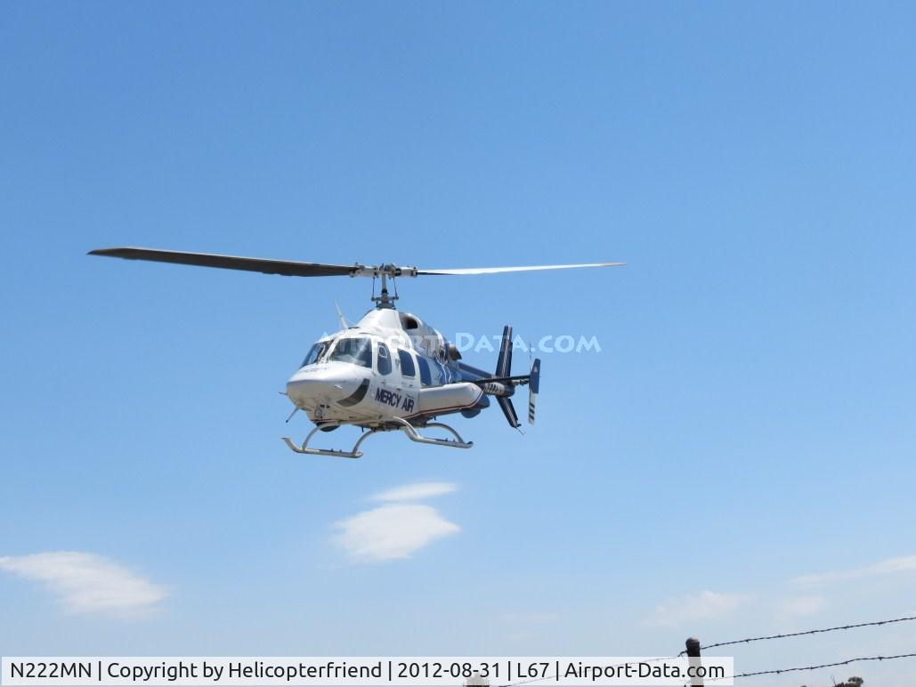 N222MN, 1984 Bell 222U C/N 47534, Lifting straight up, headed northbound preparing to take off