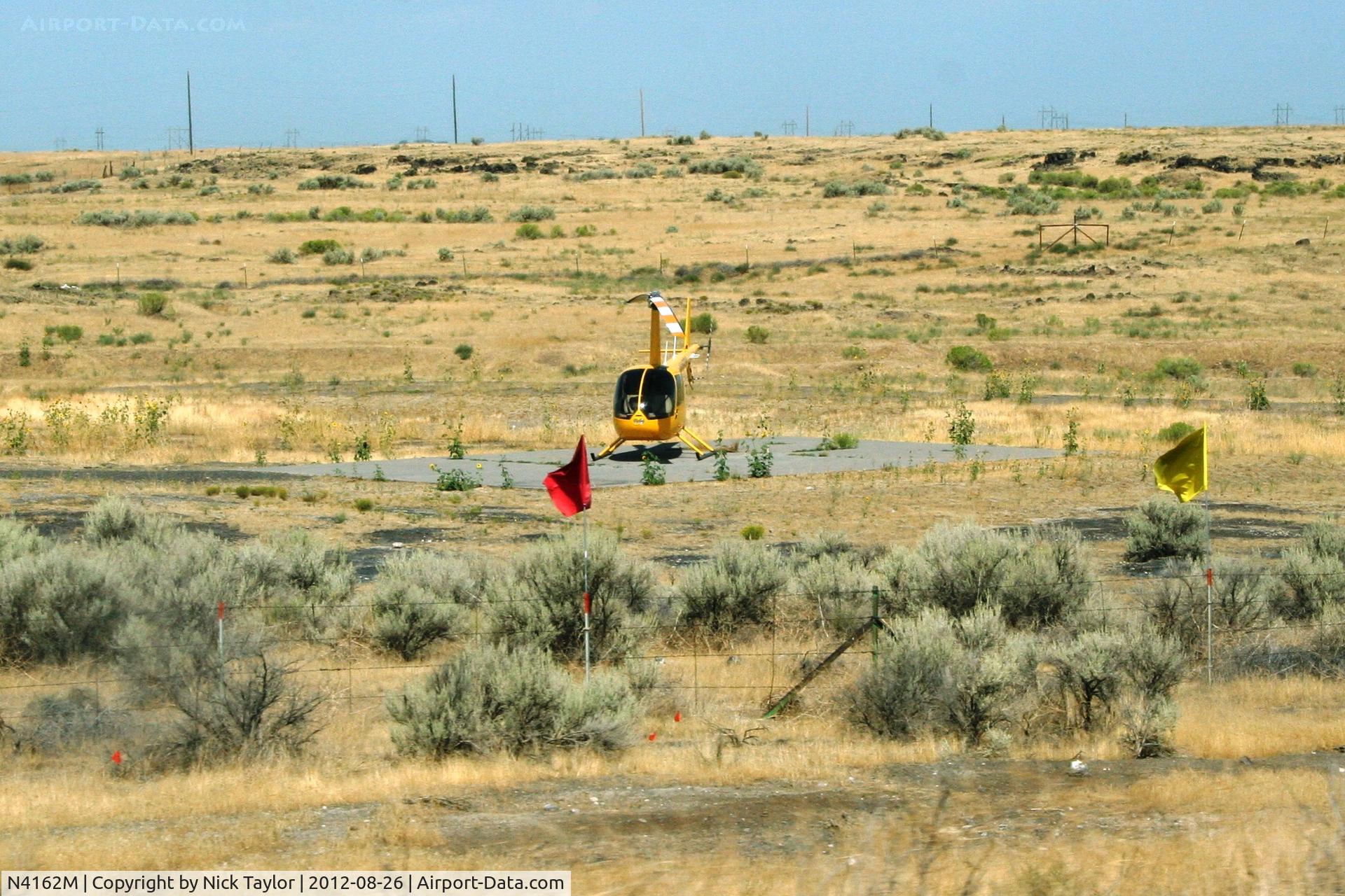 N4162M, 2008 Robinson R44 C/N 1877, Parked alongside HWY 93 and Golf Course rd. just north of Twin Falls, Id. selling tour rides.