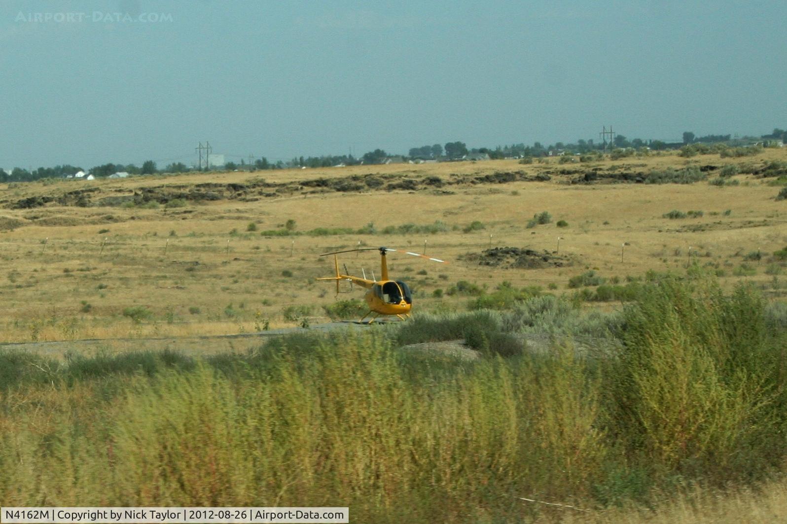 N4162M, 2008 Robinson R44 C/N 1877, Parked along HWY 93 and Golfcourse rd. just north of Twin Falls Id.