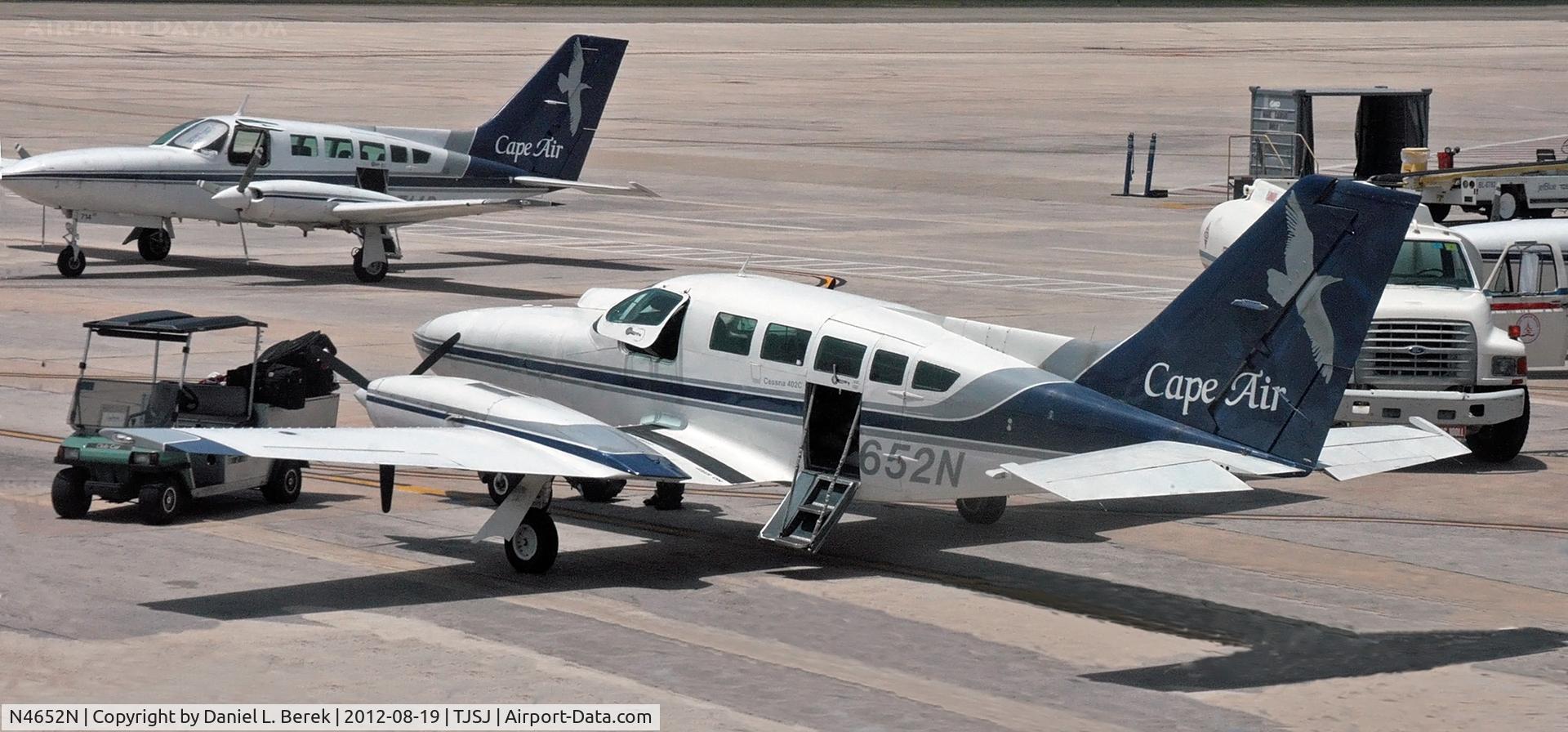 N4652N, 1978 Cessna 402C C/N 402C0011, A Cape Air Cessna sits, surrounded by ground support equipment at SJU.