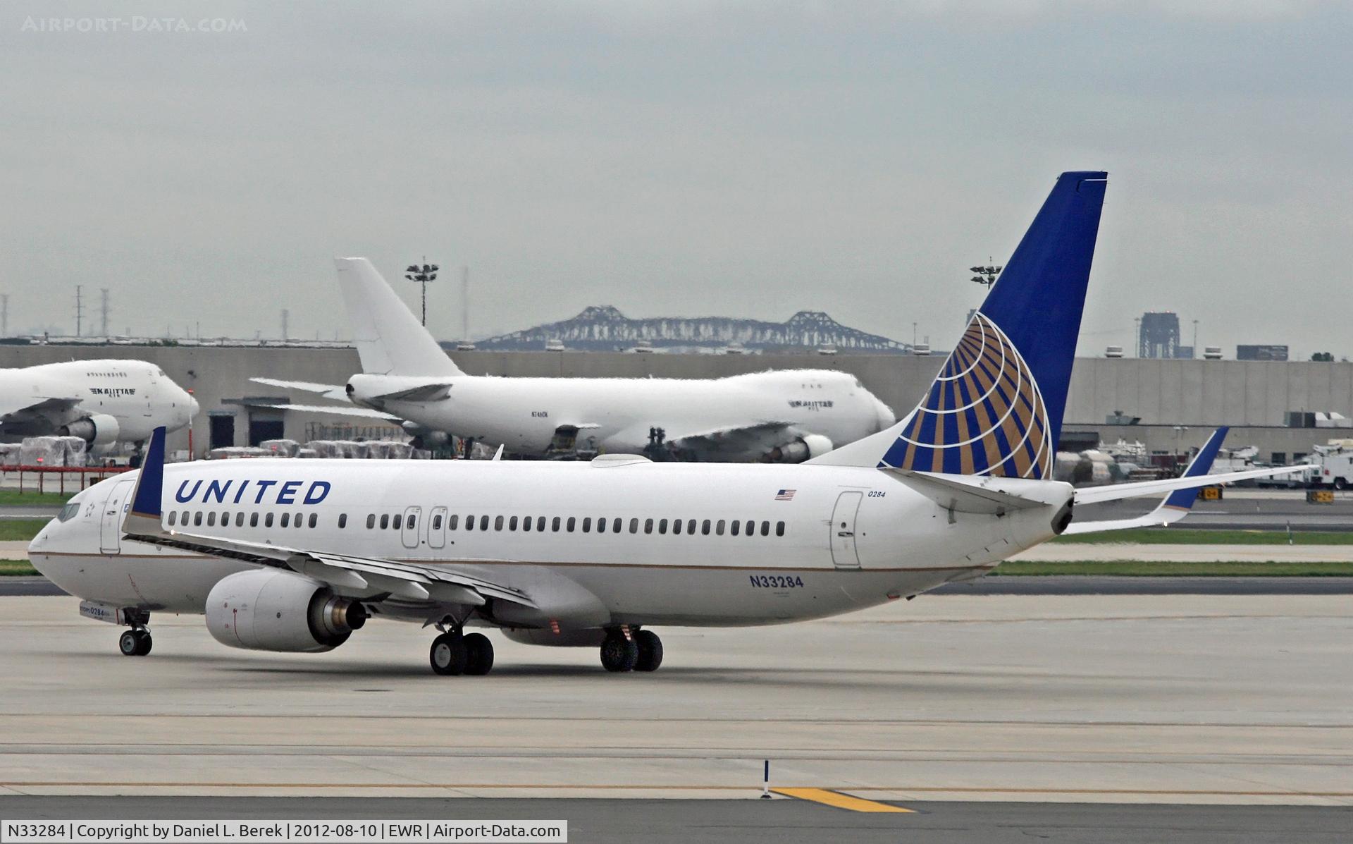 N33284, 2004 Boeing 737-824 C/N 31635, A United 737-800 joins the crowd of aircraft that has assembled on the Newark apron after many flights were delayed because of thunderstorms.