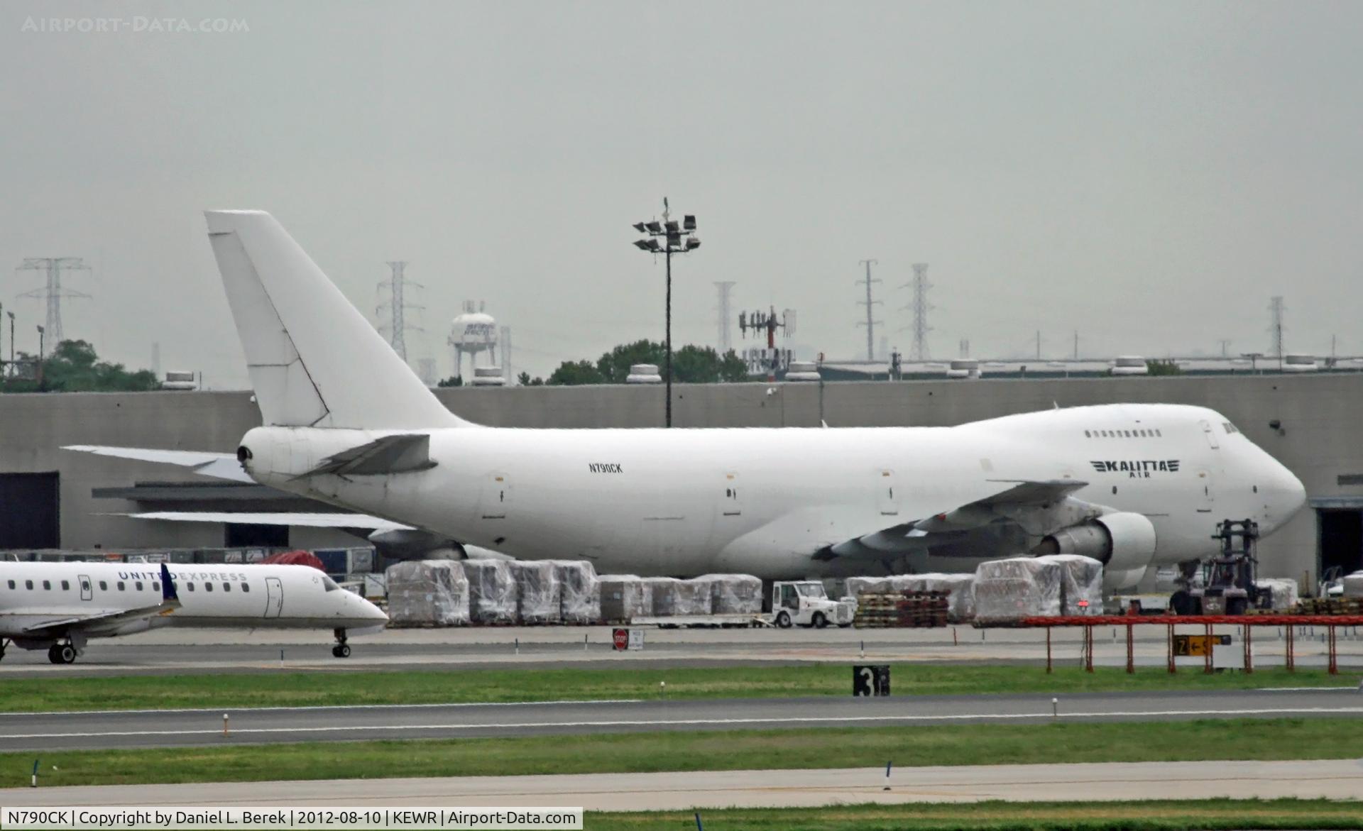 N790CK, 1984 Boeing 747-251B C/N 23112, A classic 747 freighter is surrounded by goods on the far side of the Newark ramp.  This Jumbo was built in 1984 for Northwest.