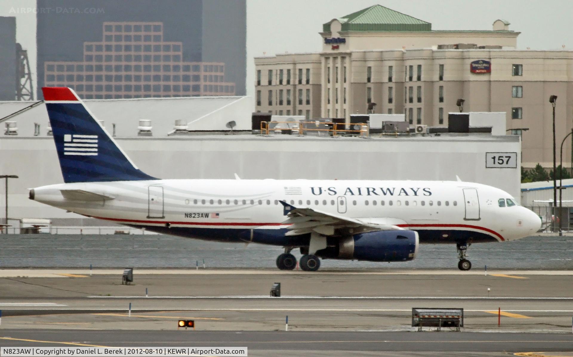 N823AW, 2001 Airbus A319-132 C/N 1463, Zooming in at aircraft on the far-end taxiway produces some interesting effects.